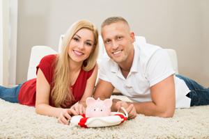 Couple holding a piggy bank